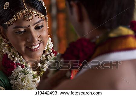 Stock Image - Young couple during wedding ceremony . Fotosearch