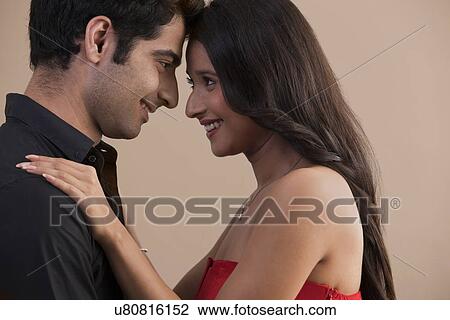 Young couple having a lovely time together at home View Large Photo Image Stock Image - Young couple having a lovely time together at home . Fotosearch