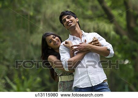 Stock Image - Young couple in a park . Fotosearch