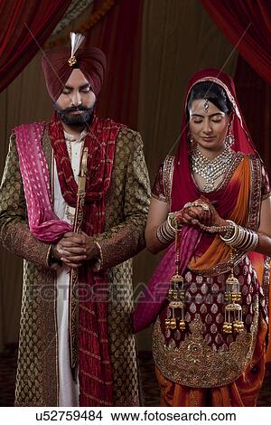 Young couple in traditional Indian clothing View Large Photo Image Picture - Young couple in traditional Indian clothing . Fotosearch