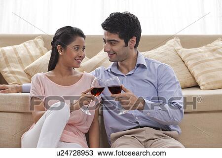 Young couple toasting wine at home View Large Photo Image Stock Image - Young couple toasting wine at home . Fotosearch