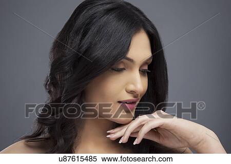 Stock Photography - Young female with beautiful hair over colored background . Fotosearch