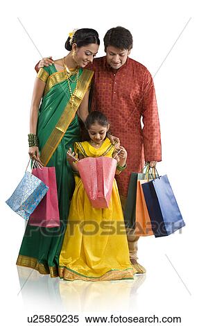 Stock Photography - Young girl looking inside a shopping bag . Fotosearch