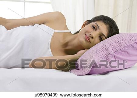 Young girl lying in bed View Large Photo Image Stock Photo - Young girl lying in bed . Fotosearch