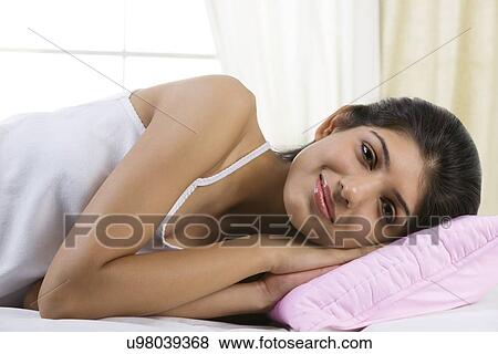 Young girl lying in bed View Large Photo Image Stock Photo - Young girl lying in bed . Fotosearch