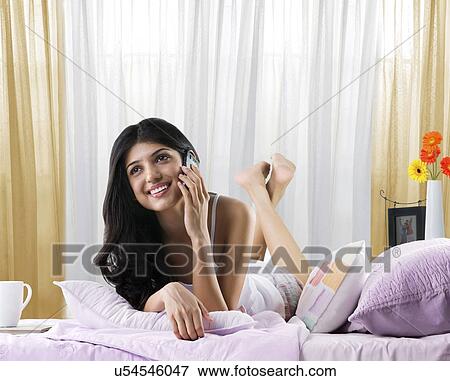 Young girl talking on a mobile phone View Large Photo Image Stock Photo - Young girl talking on a mobile phone . Fotosearch