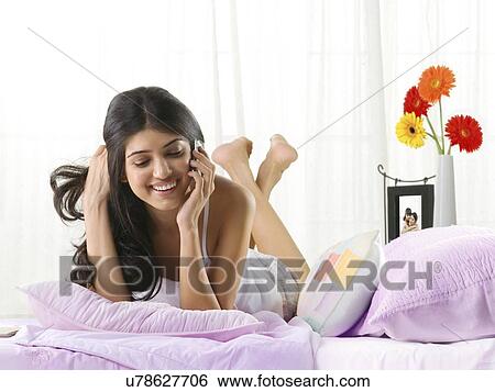 Young girl talking on a mobile phone View Large Photo Image Stock Photograph - Young girl talking on a mobile phone . Fotosearch