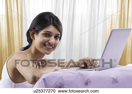 Young girl with a laptop View Large Photo Image Stock Image - Young girl with a laptop . Fotosearch