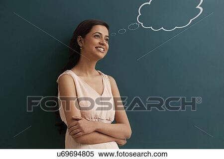 Young happy female teacher with thought bubble on chalk board View Large Photo Image Stock Photography - Young happy female teacher with thought bubble on chalk board . Fotosearch