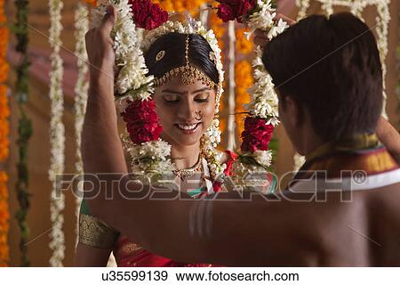 Stock Photo - Young Indian couple during wedding ceremony . Fotosearch