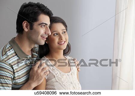 Young Indian couple enjoying the view together View Large Photo Image Stock Photograph - Young Indian couple enjoying the view together . Fotosearch
