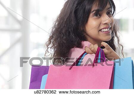 Stock Image - Young Indian woman shopping . Fotosearch