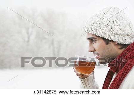 Young man drinking black tea outdoors View Large Photo Image Stock Photography - Young man drinking black tea outdoors . Fotosearch