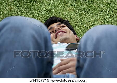 Young man listening to music View Large Photo Image Stock Photography - Young man listening to music . Fotosearch