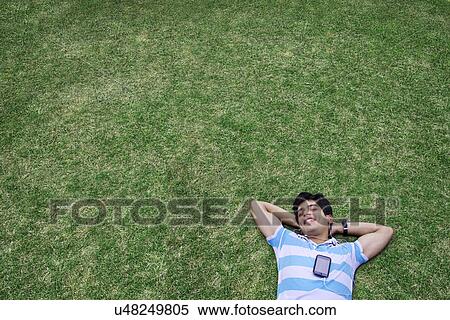 Stock Photography - Young man listening to music . Fotosearch