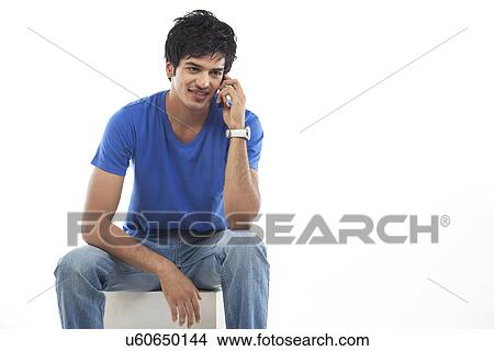 Young man on the phone over white background View Large Photo Image Picture - Young man on the phone over white background . Fotosearch