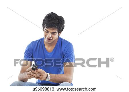 Young man reading text message over white background View Large Photo Image Stock Image - Young man reading text message over white background . Fotosearch
