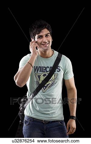 Picture - Young man talking on a mobile phone . Fotosearch