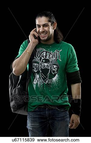 Young man talking on a mobile phone View Large Photo Image Stock Photo - Young man talking on a mobile phone . Fotosearch