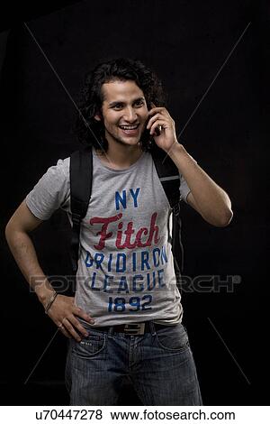 Stock Photo - Young man talking on a mobile phone . Fotosearch