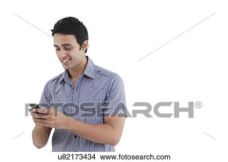 Picture - Young man text messaging . Fotosearch