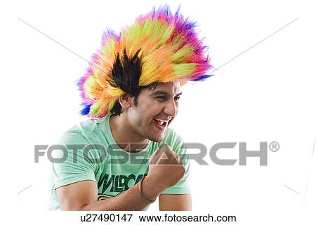 Stock Photo - Young man with a wig cheering . Fotosearch