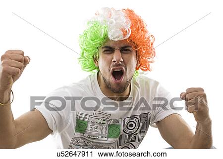 Young man with a wig rejoicing View Large Photo Image Stock Image - Young man with a wig rejoicing . Fotosearch