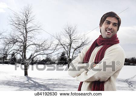 Young man with bare trees in the background View Large Photo Image Stock Image - Young man with bare trees in the background . Fotosearch