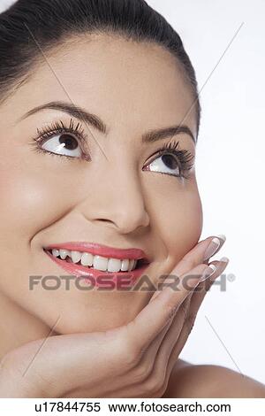 Stock Photography - Young smiling woman looking up . Fotosearch