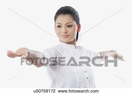 Young smiling woman with arms outstretched looking away View Large Photo Image Stock Image - Young smiling woman with arms outstretched looking away . Fotosearch