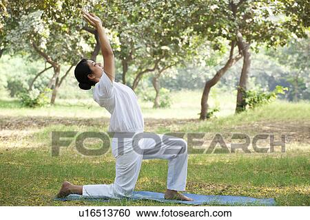 Young woman doing stretching exercise View Large Photo Image Stock Image - Young woman doing stretching exercise . Fotosearch