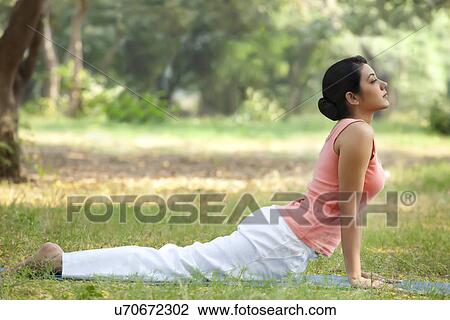 Young woman doing yoga in lawn View Large Photo Image Stock Image - Young woman doing yoga in lawn . Fotosearch