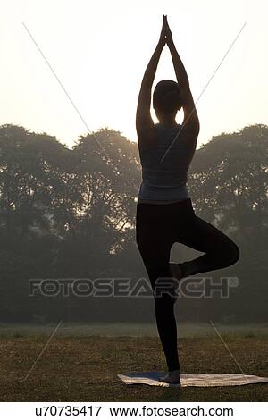 Stock Photo - Young woman doing yoga practice . Fotosearch