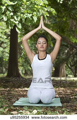 Picture - Young woman doing yoga with hands in prayer position . Fotosearch