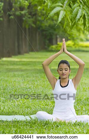 Young woman doing yoga with hands in prayer position View Large Photo Image Stock Image - Young woman doing yoga with hands in prayer position . Fotosearch