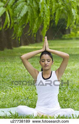 Stock Photo - Young woman doing yoga with hands in prayer position . Fotosearch