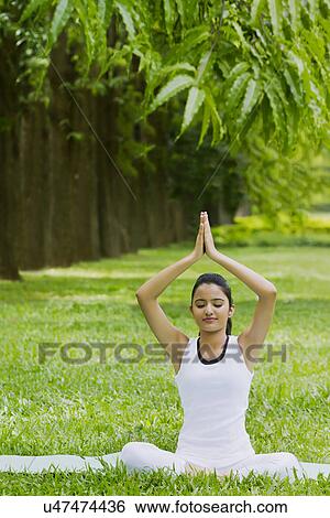 Young woman doing yoga with hands in prayer position View Large Photo Image Stock Photograph - Young woman doing yoga with hands in prayer position . Fotosearch