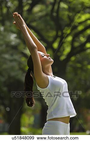 Young woman doing yoga with hands outstretched View Large Photo Image Stock Photo - Young woman doing yoga with hands outstretched . Fotosearch