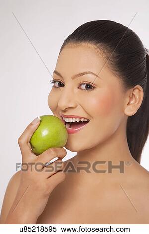 Young woman eating green apple View Large Photo Image Stock Photography - Young woman eating green apple . Fotosearch