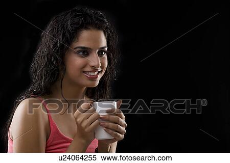 Young woman holding a mug View Large Photo Image Stock Photography - Young woman holding a mug . Fotosearch