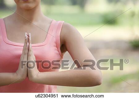 Young woman holding hands in prayer position View Large Photo Image Stock Image - Young woman holding hands in prayer position . Fotosearch
