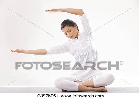Young woman in casual clothes practicing yoga View Large Photo Image Stock Image - Young woman in casual clothes practicing yoga . Fotosearch