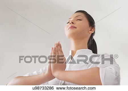 Young woman in prayer position View Large Photo Image Stock Photograph - Young woman in prayer position . Fotosearch