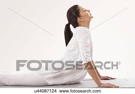 Young woman in upward facing dog position View Large Photo Image Picture - Young woman in upward facing dog position . Fotosearch
