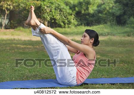 Young woman in yoga position View Large Photo Image Stock Image - Young woman in yoga position . Fotosearch
