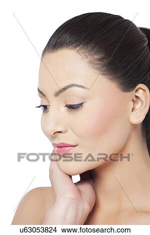 Young woman looking down over white background View Large Photo Image Picture - Young woman looking down over white background . Fotosearch