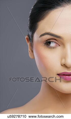 Young woman looking sideways over colored background View Large Photo Image Stock Image - Young woman looking sideways over colored background . Fotosearch