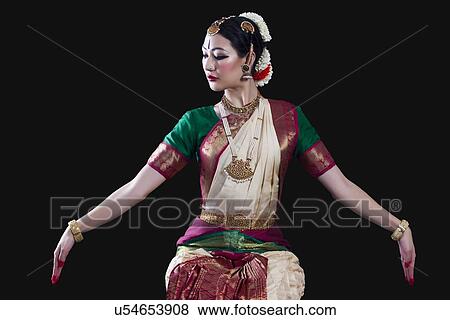 Young woman making Bharatanatyam gesture called Dola-Hastam on black background View Large Photo Image Stock Photo - Young woman making Bharatanatyam gesture called Dola-Hastam on black background. Fotosearch