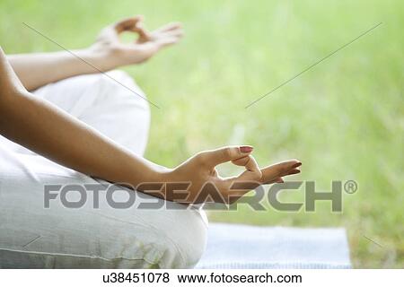Young woman meditating in lawn View Large Photo Image Stock Photo - Young woman meditating in lawn . Fotosearch