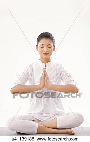 Stock Photo - Young woman meditating . Fotosearch